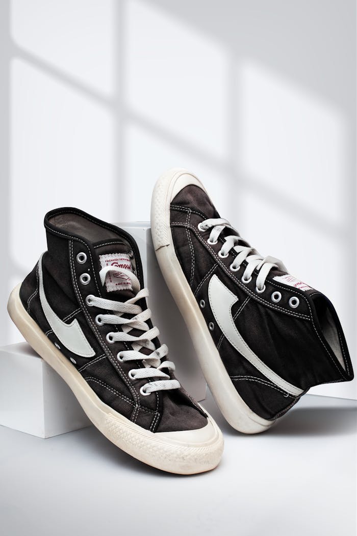 Black and white high top sneakers displayed on a white background, perfect for fashion use.